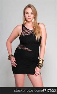 Pretty young plus size blonde in a black dress