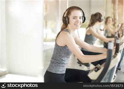 Pretty young sport woman is exercise on bicycle in gym, Healthy lifestyle