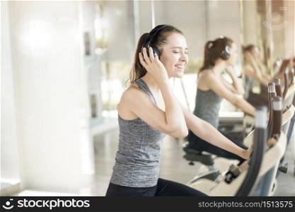 Pretty young sport woman is exercise on bicycle in gym, Healthy lifestyle