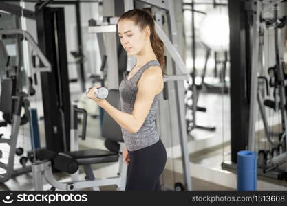 Pretty young sport woman is Workout in gym, Healthy lifestyle