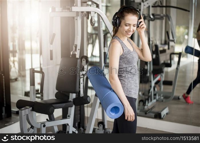 Pretty young sport woman is workout with mat in gym, Healthy lifestyle