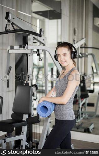 Pretty young sport woman is workout with mat in gym, Healthy lifestyle
