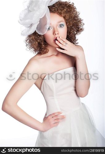 Pretty young surpised woman in white wedding dress isolated Studio shot