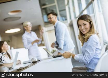 Pretty young woman and group business people have a meeting and working in the office