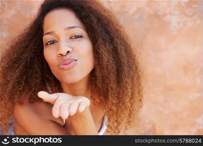 Pretty Young Woman Blowing Kiss Towards Camera