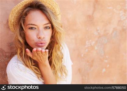 Pretty Young Woman Blowing Kiss Towards Camera