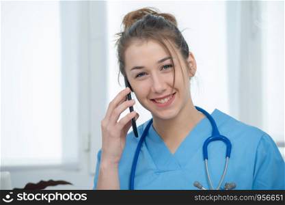 pretty young woman doctor talking on the phone