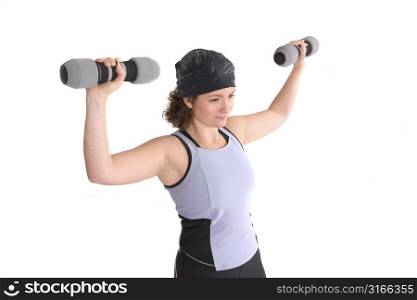 Pretty young woman doing a workout with weights