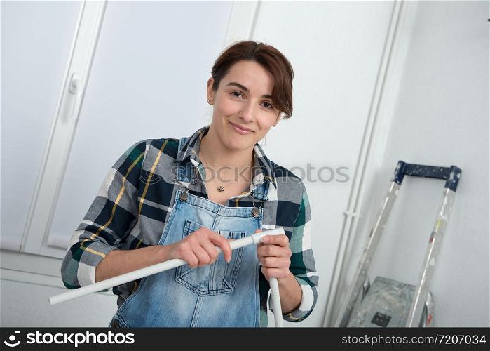 pretty young woman doing DIY work at home