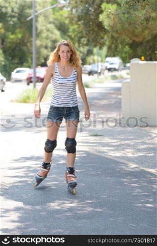 pretty young woman doing roller skate