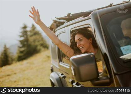 Pretty young woman enjoying freedom in terrain vehicle on a sunny day