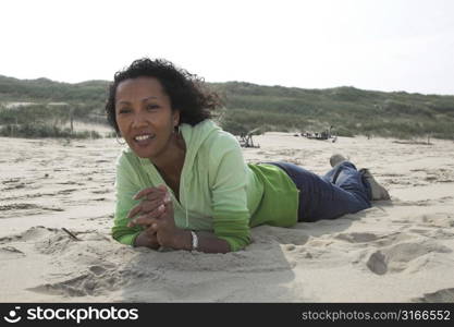 Pretty young woman enjoying the sunshine on the beach