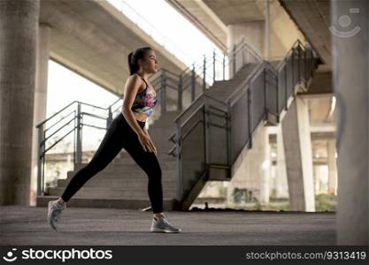 Pretty young woman exercise in urban environment