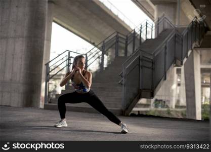 Pretty young woman exercise in urban environment