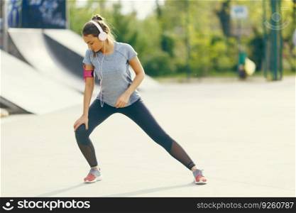 Pretty young woman having exercise outdoors