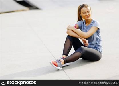 Pretty young woman having exercise outdoors