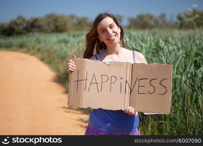 Pretty young woman holding happiness card