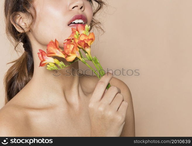 pretty young woman holding vibrant flowers