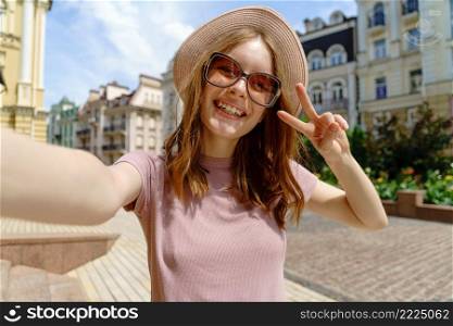 Pretty young woman in glasses making selfie at city center.. Pretty young woman in glasses making selfie at city center
