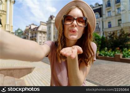 Pretty young woman in glasses making selfie at city center.. Pretty young woman in glasses making selfie at city center