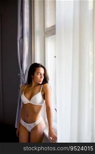 pretty young woman in lingerie by the window