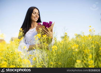 Pretty young woman in the rapeseed field