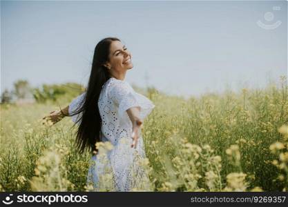 Pretty young woman in the rapeseed field