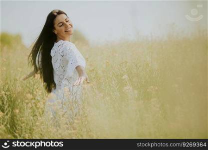 Pretty young woman in the rapeseed field