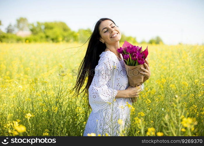 Pretty young woman in the rapeseed field