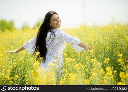 Pretty young woman in the rapeseed field