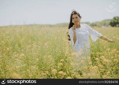 Pretty young woman in the rapeseed field