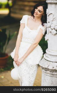 Pretty young woman in white dress on the street