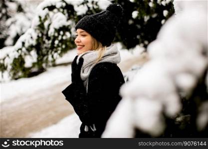Pretty young woman n warm clothes enjoying in snow