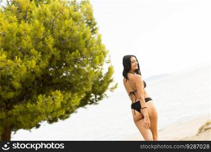 Pretty young woman on the beach at summer