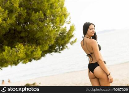 Pretty young woman on the beach at summer