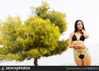 Pretty young woman on the sandy beach at summer