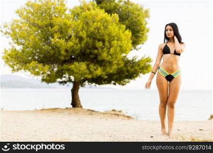 Pretty young woman on the sandy beach at summer