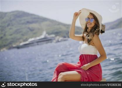 Pretty young woman relaxing by the sea