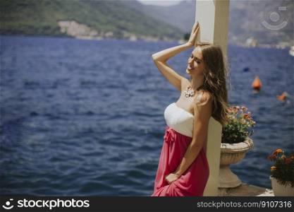 Pretty young woman relaxing by the sea