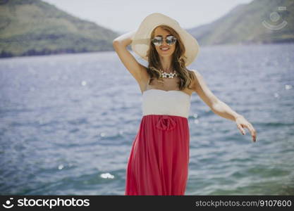 Pretty young woman relaxing by the sea