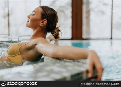 Pretty young woman relaxing in the whirlpool bathtub