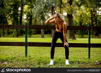 Pretty young woman resting after the outdoor training