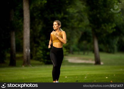 Pretty young woman running in park