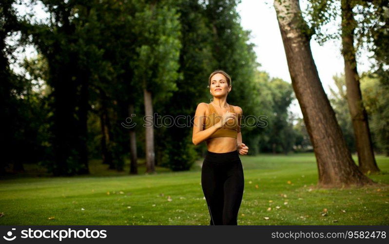 Pretty young woman running in park