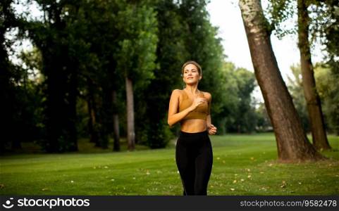 Pretty young woman running in park