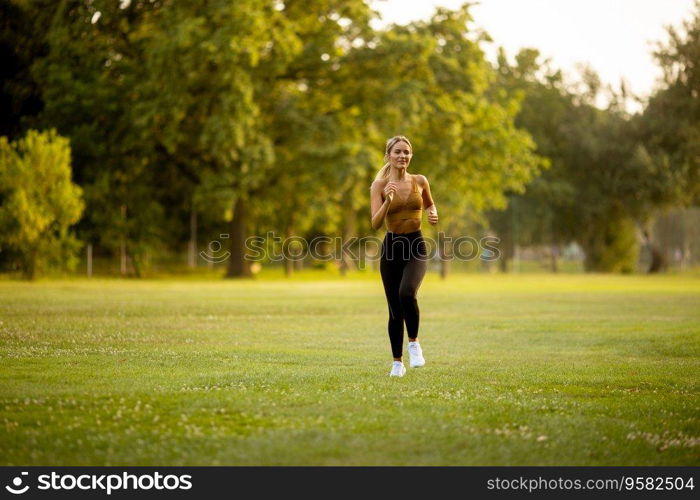 Pretty young woman running in park