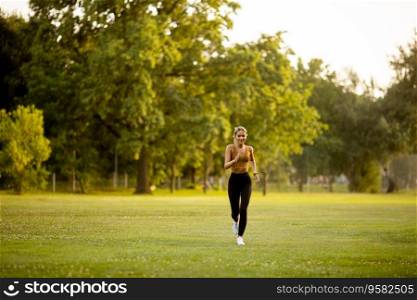 Pretty young woman running in park