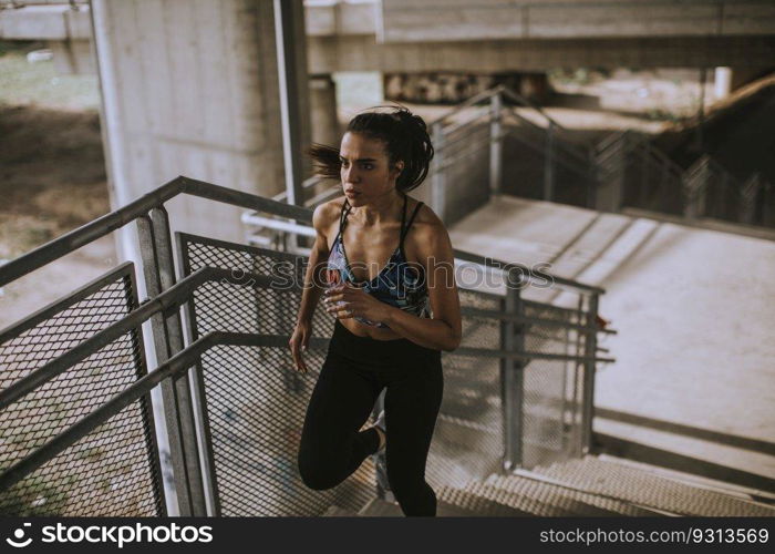 Pretty young woman running in the urban environment