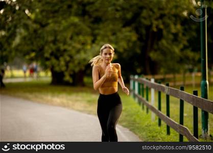 Pretty young woman running on a lane in the park