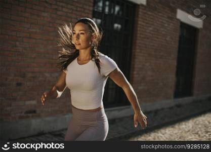 Pretty young woman running on the street
